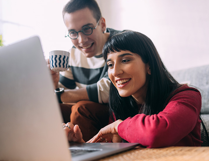 Couple checking computer