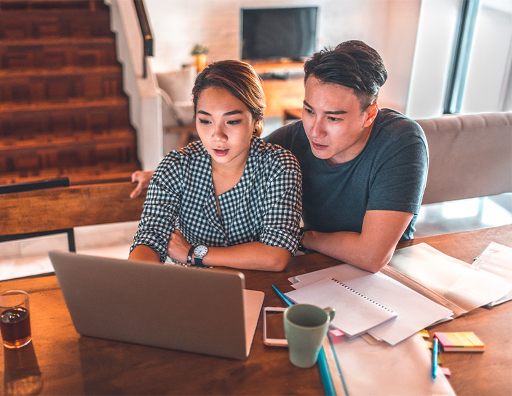 Couple checking computer